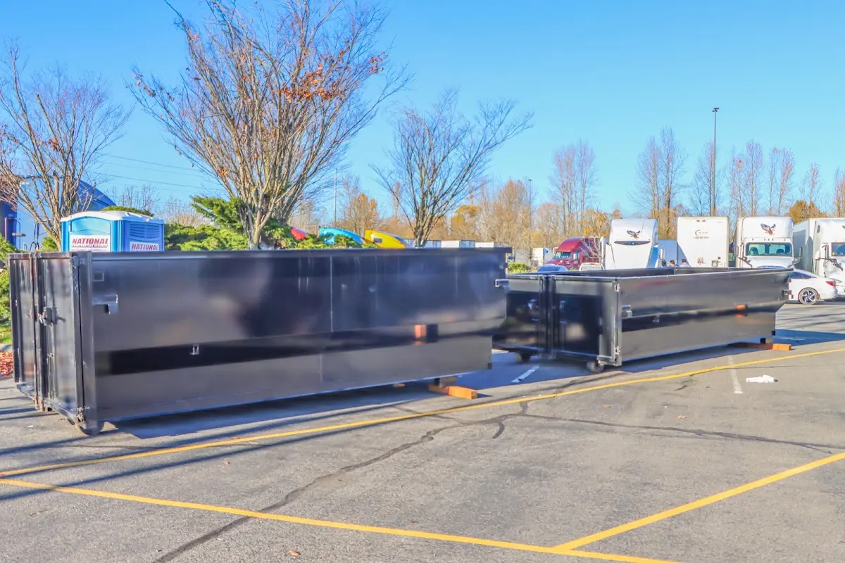 Professional dumpster rental service with roll-off container on residential driveway in Wedgefield